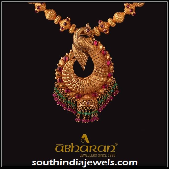 Gold Antique peacock pendant from Abharan Jewellers